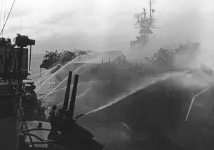 Alan Reed ’40 died after boarding the USS Princeton, in flames, Oct. 24, 1944. He was assigned to the USS Birmingham, shown here fighting the fire.