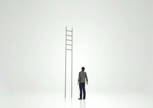 Man looking at ladder with rungs out of reach