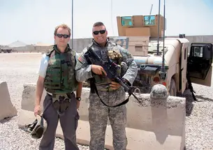 Author Whitney Terrell, left, with Nate Rawlings '04 at Camp Liberty in Iraq in July 2006.
