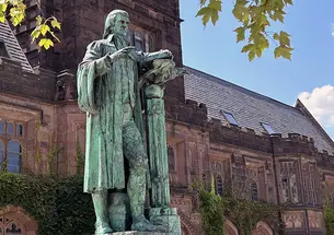 Princeton’s statue of John Witherspoon, turning green outdoors.