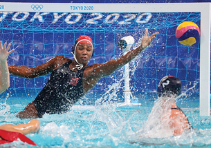 Ashleigh Johnson leaps to her left to save a shot