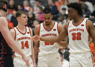 Left to right, Matt Allocco ’24, Tosan Evbuomwan ’23, and Keeshawn Kellman ’23 talking on the court at Jadwin Gym