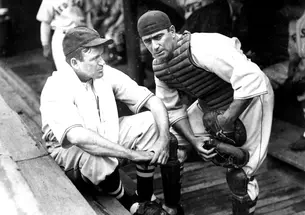 Moe Berg '23 and player-manager Joe Cronin in the Boston Red Sox dugout, circa 1937. Berg played in the major leagues for 15 seasons, mostly as a backup catcher, compiling a .243 lifetime batting average.
