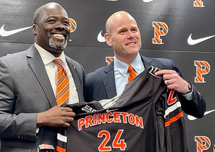 Athletics director John Mack ’00, left, and men’s hockey coach Ben Syer, right hold a Princeton hockey jersey at an April 26 press conference. 