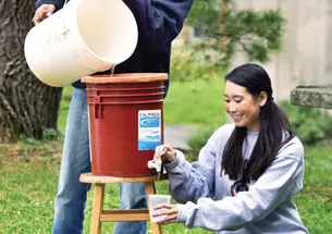 Mechanical and aerospace engineering graduate student Ismaiel Yakub and civil and environmental engineering major Megan Partridge ’14 join forces to demonstrate a ceramic filter system that promises to remove pathogenic bacteria from African drinking wa