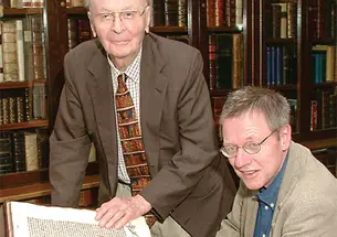 In this 2002 photo, William H. Scheide ’36 (standing) and Scheide Librarian Paul Needham look over some of the first printed editions of the Bible, which are part of the magnificent collection of rare books and manuscripts that now have a permanent home