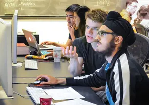 Student demand for computer science courses is skyrocketing. Here, students collaborate on computer science problem sets in the Friend Center.