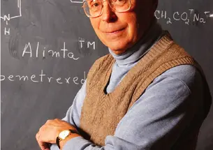  Edward C. Taylor, the A. Barton Hepburn Professor of Organic Chemistry, Emeritus, stands in front of the chemical diagram of Alimta, a powerful cancer-fighting drug that he developed.