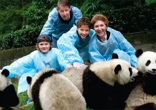 Dean Slaughter, Professor Moravcsik, and their children, Edward (left) and Alexander, at the Wolong Panda Reserve—the largest in China.