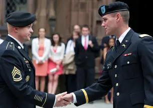Thomas Boggiano ’12 gets a handshake from Sgt. 1st Class Gregory Bentow after receiving his first salute as an officer.