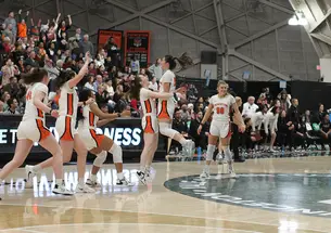 Players celebrating on court with arms raised