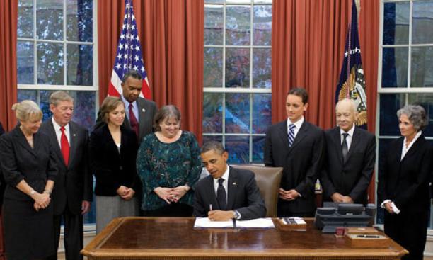 First Response Action board member and legislative liaison Kate Finn ’06, third from left, at the White House as President Obama signs the Kate Puzey Peace Corps Volunteer Protection Act of 2011 into law Nov. 21.