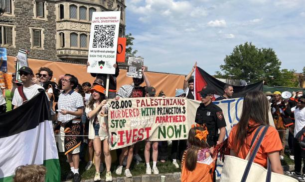 Protesters hold signs at the P-rade; one reads: "28,000 Palestinians murdered with Princeton $. Stop Israeli apartheid. Divest Now!"