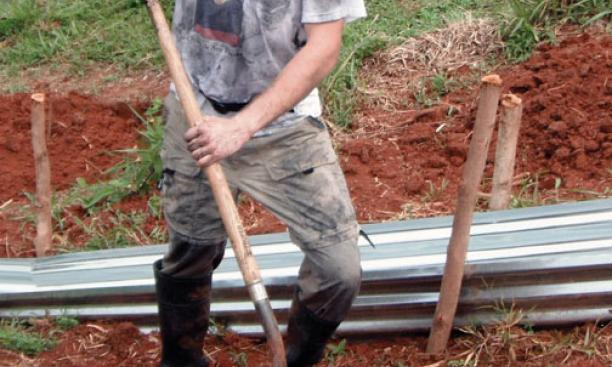 Danny Growald ’11 mixes biochar into the soil on the Osa Peninsula of Costa Rica.