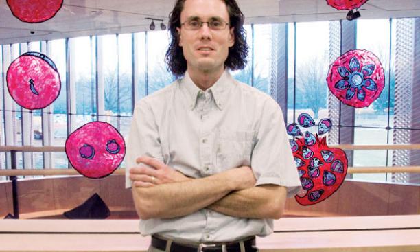 Assistant professor Manuel Limas hopes to find ways to break the malaria parasite's 48-hour cycle, depicted in the illustrations at Icahn Lab.