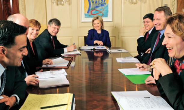 Anne-Marie Slaughter ’80, right, shares a lighter moment at a meeting with Secretary of State Hillary Clinton, ­center, and other foreign-policy staff. At left is assistant secretary Richard Verma. 