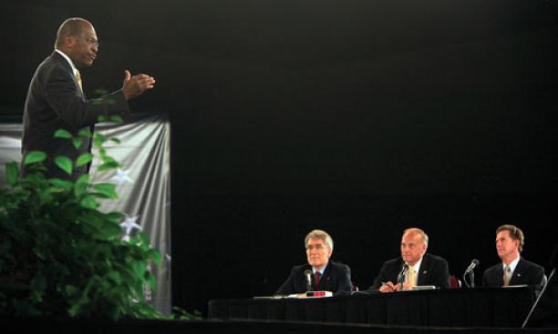 Republican presidential hopeful Herman Cain responds to a question from the Palmetto Freedom Forum’s panelists: from left, ­Professor Robert George, Rep. Steve King, and Sen. Jim DeMint.