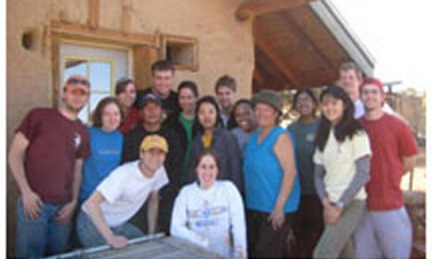 Students who took part in the Breakout trip to Big Mountain, Arizona, a community on the Navajo Nation Native American reservation, stand in front of a home and straw bale that they worked on as part of their sustainable building project.  From left are T