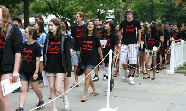 At the Pre-rade, freshmen enter campus with classmates from their residential colleges, wearing college-specific T-shirts.