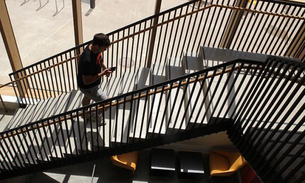 David Heath ’25 of Sparta, New Jersey, a player on the football team, walks up the stairs in Yeh College.