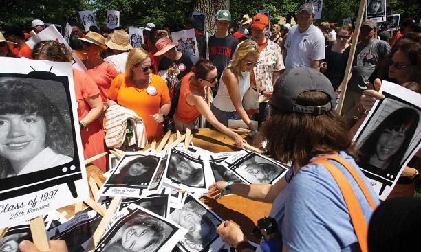 Members of the Class of 1997 pick up signs with their Nassau Herald photos to use in the “’97 Prime Time 25th Reunion Special.”