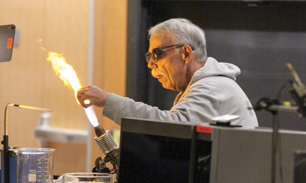 Mike Souza, the recently retired scientific glassblower in the chemistry department, entertains
