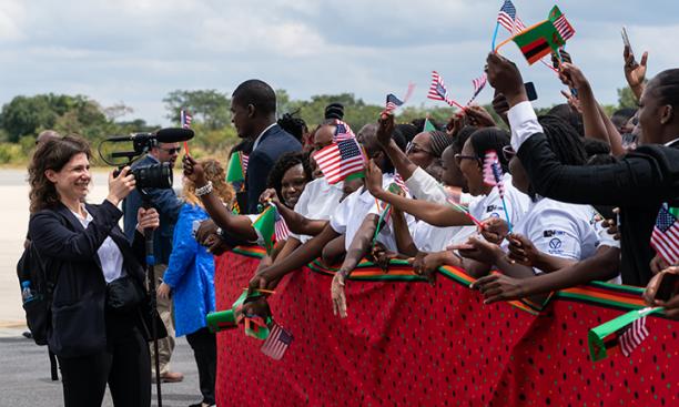 Azza Cohen ’16 films a crowd of cheering people waving American and Zambian flags in Zambia