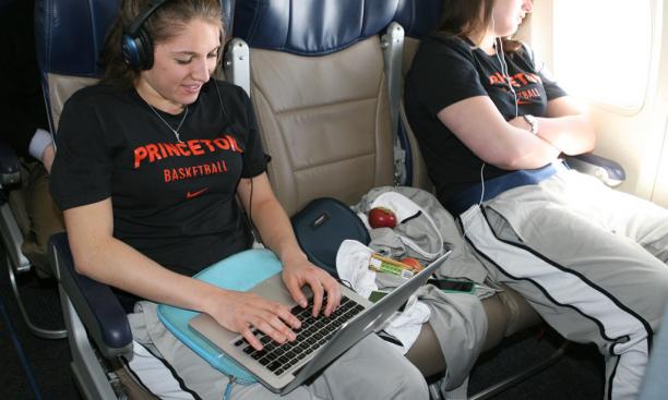 On the flight to the host site in Waco, Texas, Lauren Polansky '13, left, catches up on work while Meg Bowen '13 catches up on rest.