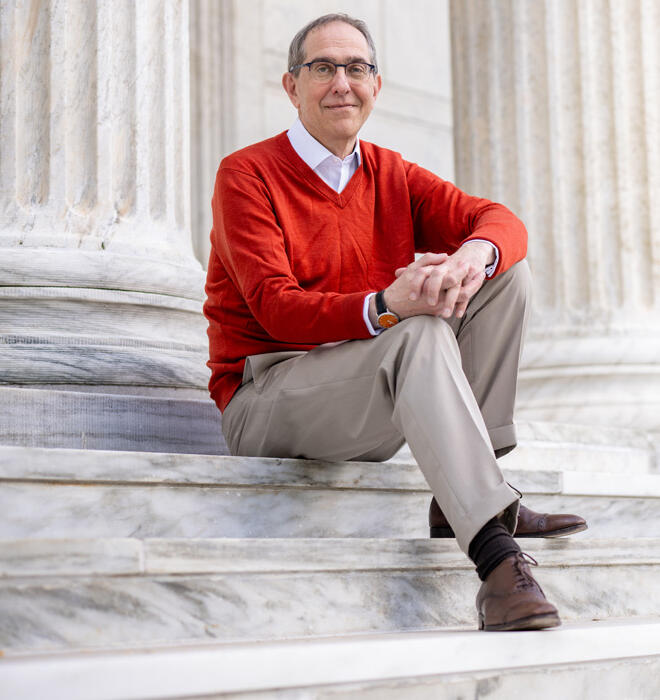 President Eisgruber sits on the steps on Whig Hall