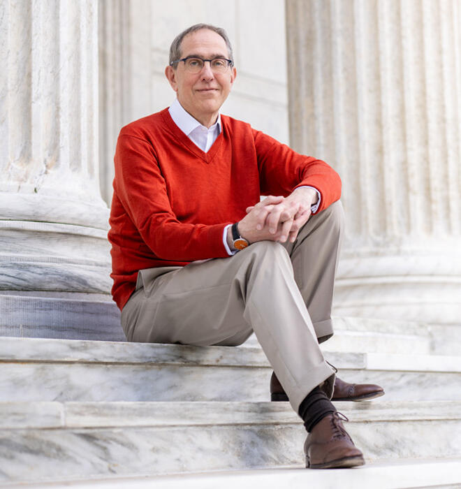 President Eisgruber sits on the steps on Whig Hall