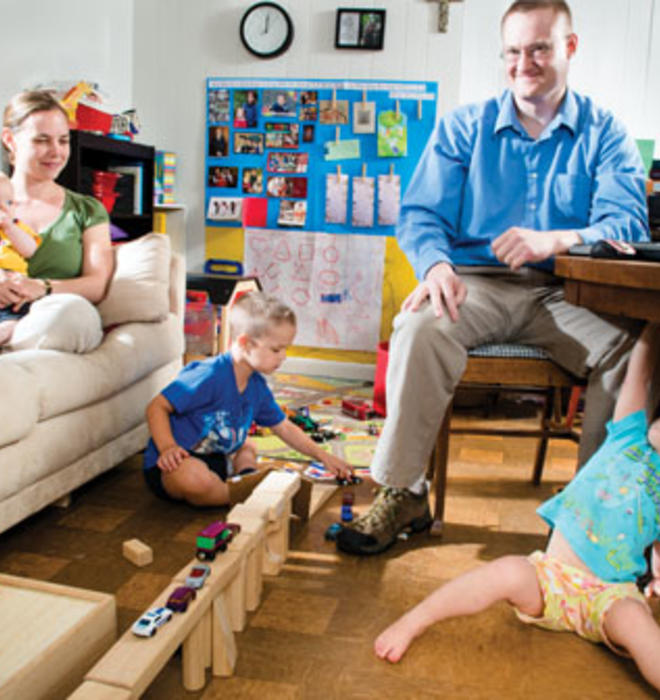 Dan Johnson GS; his wife, Julie; and their children Anders (5), Lucia (2), and Henrik (5 months) make good use of their small living room.