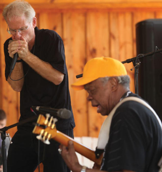 Adam Gussow ’79 *00, left, and his partner in music, Sterling Magee, known as Satan, perform at the Hill Country Harmonica festival in May.