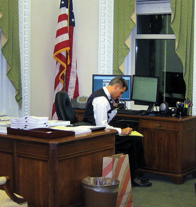 Dressed for a White House party, Alan Krueger works on statistics needed for a 2011 presidential speech.