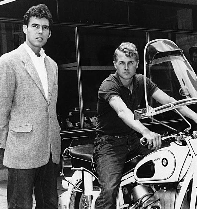 John Hopkins ’60 sits on a motorcycle to the right, while friend Joe McPhillips ’58 stands on the left in this black-and-white photo. The pair’s motorcycle journey through North Africa in the 1960s was the subject of Hopkins’ The White Nile Diaries. This image appeared on the cover of the book.