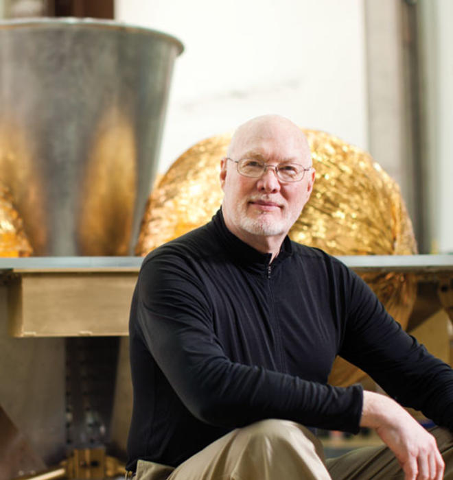 William L. “Red” Whittaker ’73 sits in front of the lunar lander in his lab at Carnegie Mellon University.