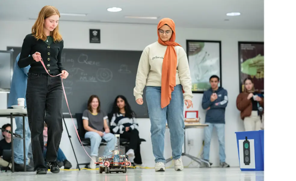 OTC_Car Lab 1.jpg Caroline Rasmussen ’26, left, and Yushra Guffer ’26 present their Car Lab vehicle at the end of the semester, a tradition that began in the 1990s