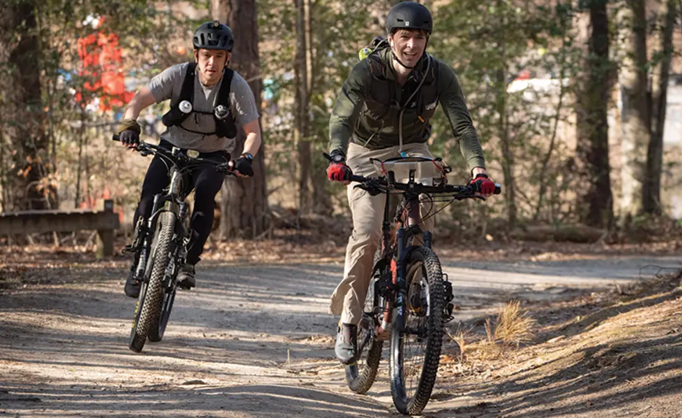 PRINCE_adventureracers_1.jpg Two men ride bicycles.