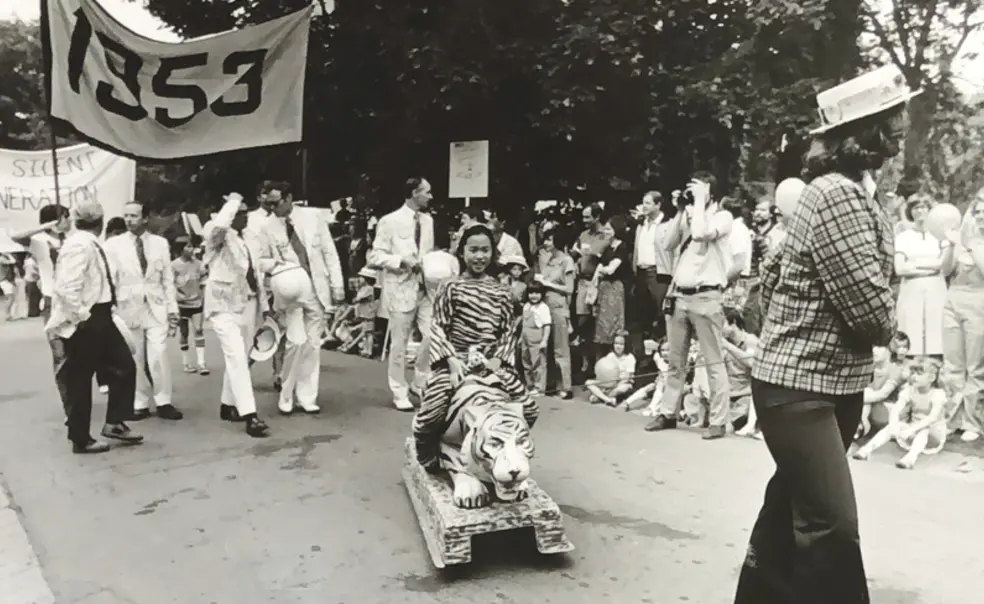RG_Family Affair.jpg Black and white photo of the 1977 P-rade featuring a little girl dressed in a tiger costume being pulled by a female marcher in front of the Class of 1953 marching