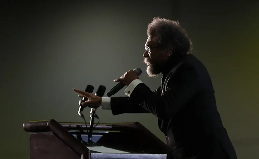 AP_20067788733487.jpg This is a photo of Cornel West, in profile, speaking at a podium.