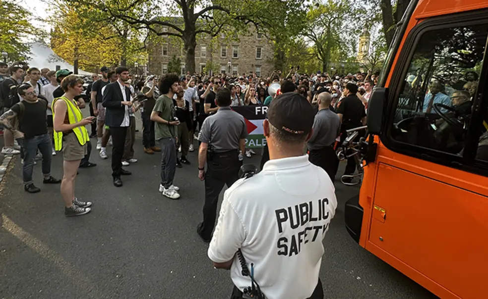 BusProtest.jpg Protesters around the bus in front of Clio Hall.