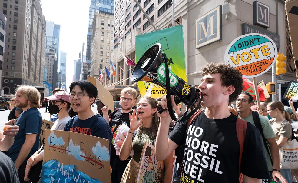 DSC05089.jpg Princeton students on a street in New York City holding signs and bullhorn while marching