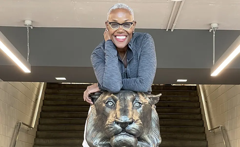 DebOnTigerInJad.jpg Deborah Saint Phard leans forward over a statue of a tiger.