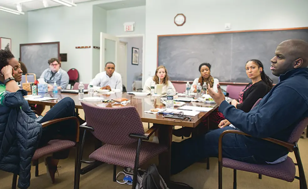 OTC-AfAmStudiesNew.jpg Paul Riley Jr. ’15, far right, discusses his thesis with professors and students at a meeting of the African American studies senior colloquium last spring.