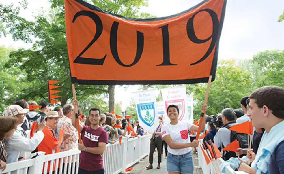 OTC-Prerade044new.jpg Josh Faires ’19 and Victoria Davidjohn ’19 carry the banner for the Pre-rade as the class is welcomed by other students and alumni.