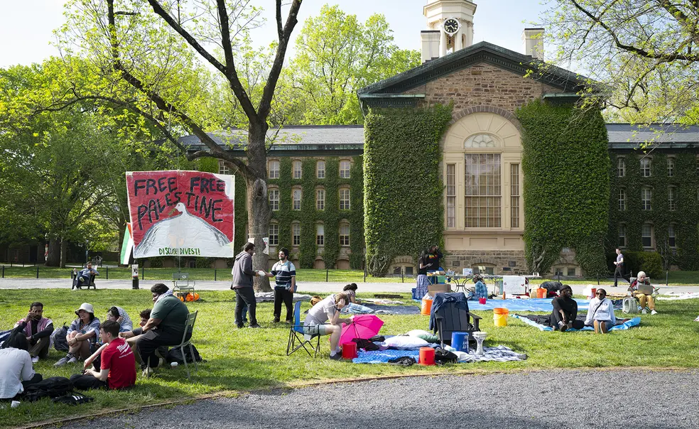Pro-Palestinian protestors on Cannon Green; a sign reads "Free Free Palestine."