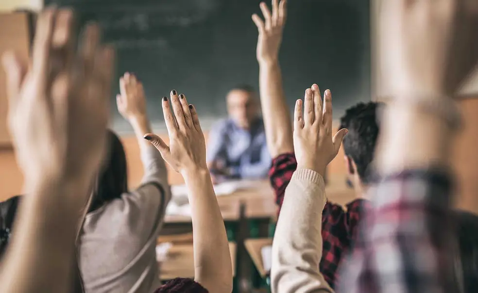 RESEARCH_Hands-up.jpg Photo of hands raised in a classroom