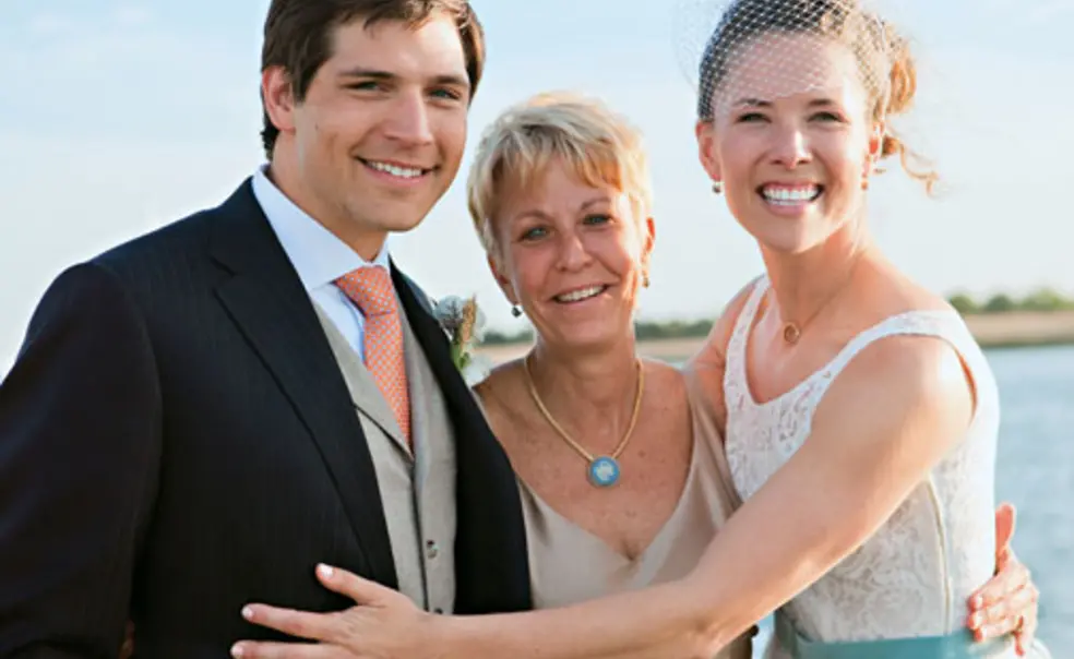 SP_ExtraPointNew.jpg Swimming coach Susan Teeter, center, officiated at the May wedding of Alyson Goodner ’00 and Paul Daniels.