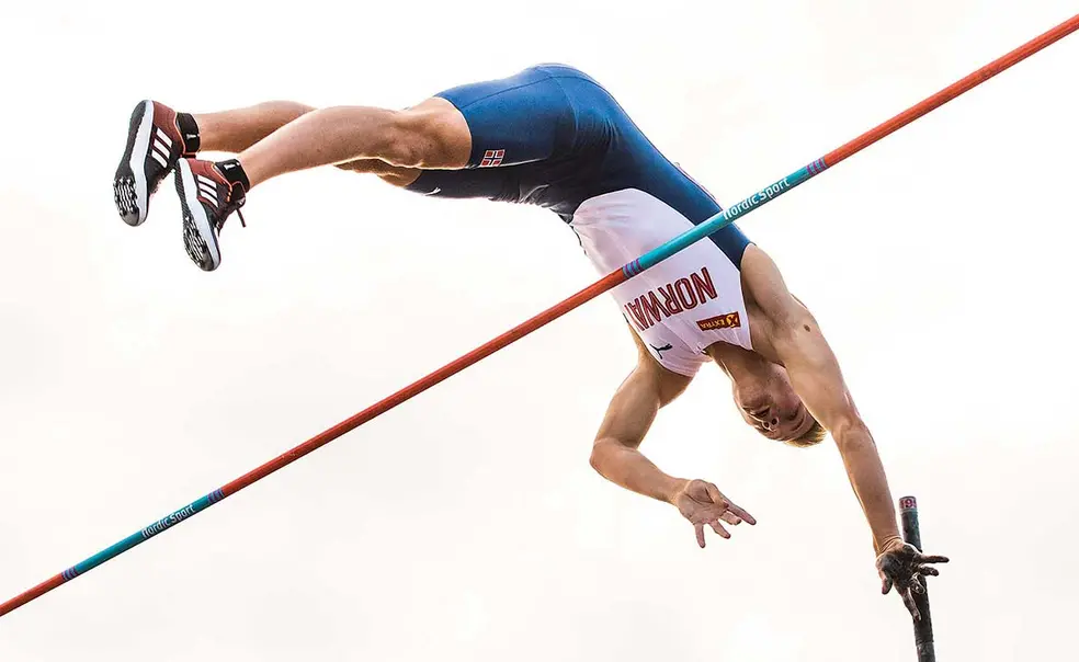 Sports.ledeNew.jpg This is a photo of Sondre Guttormsen ’23 competing in the pole vault for Norway.