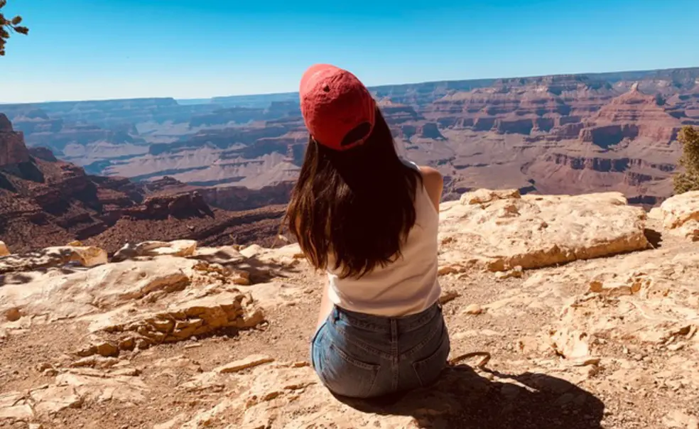 Summer Project Cassandra 1.jpg Cassandra James ’23 sits with her back to the camera, looking over a southwest scene.