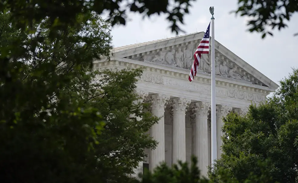 SupremeCourt_APphoto.jpg An American flag waves in front of the U.S. Supreme Court building, Monday, June 27, 2022, in Washington.